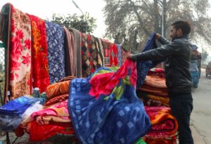 Street vendor selling blankets amidst the winter season on the streets of Srinagar City.