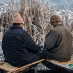 On bone chilling morning two vegetable sellers exchanging money on Dal Lake.