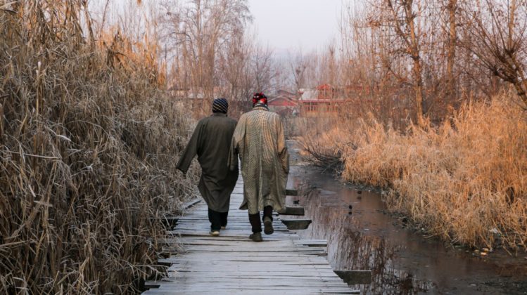Locals passing through the interiors of floating market.