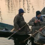 Sellers taking a break while selling their products at the floating vegetable market.