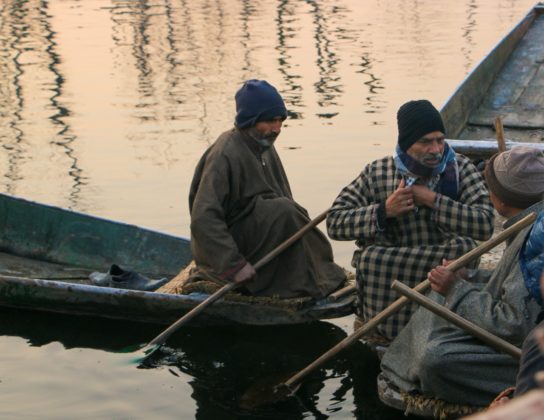 Sellers taking a break while selling their products at the floating vegetable market.