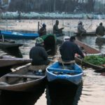 Vegetable sellers chit-chating as they gather on the famous floating market of Dal Lake.