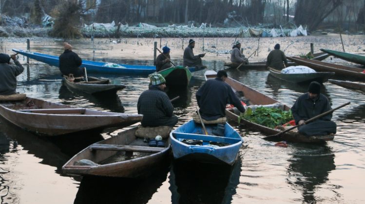 Vegetable sellers chit-chating as they gather on the famous floating market of Dal Lake.