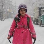 Apple cheeked Kshmiri Girl enjoying snowfall.