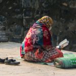 Woman reading the holy Qura'an in the compound of Khanqa-E-Maula.