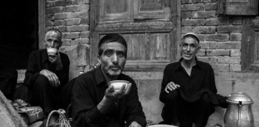 Frozen Frames: Life In Black And White In this picture, mourners are done with procession. Resting and having Kashmiri tea (Noon Chai) in a very traditional manner.